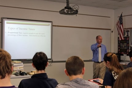 Matt Pedlow teaches civics class with an ipad.
