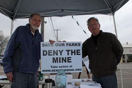Gary Zenz, on right, bought a Deny the Mine sign (and a T-shirt) Saturday at the group's information table at the Saturday Chelsea Farmers' Market.