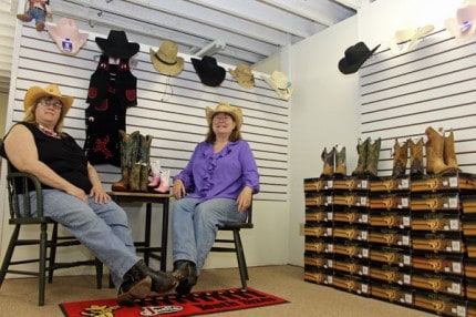 Ellen Dewey and Pam Conn pose for a photo inside Little Buckeroos, the new children's area inside Mule Skinner Boots.