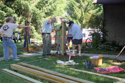 Amercan Legion Post 31 volunteers work on a handicapped ramp at the home of Ron Harris. 