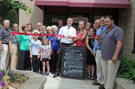 Chamber members and family members pose for a photo during the ribbon cutting for new business Phillips Family Chiropractic that took place Wednesday.