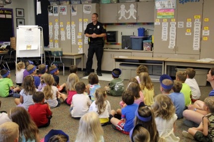 Chelsea Police Officer Shane Sumner speaks to about 60 children in the morning session of Safety Town Tuesday morning. 