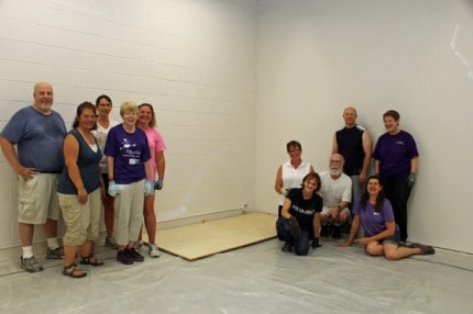 Instructors, board members and volunteers from Ballet Chelsea install the first piece of new flooring in the non-profit's new studio last month. Included in the group are 