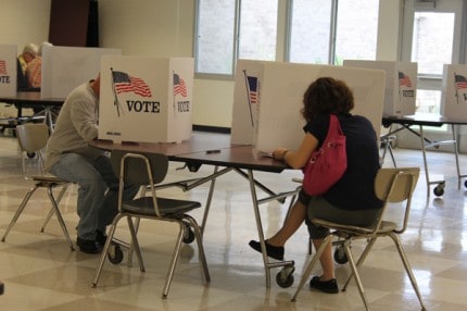 Two Chelsea residents cast their votes this morning at the Washington Street Education Center polling place. 