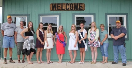 Fair board members bookend the fair queen candidates and current fair queen.