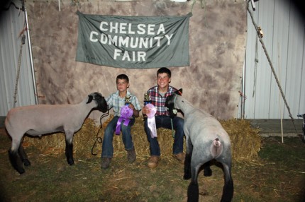 Carter and Mason Trinkle and their grand champion and reserve grand champion lambs.