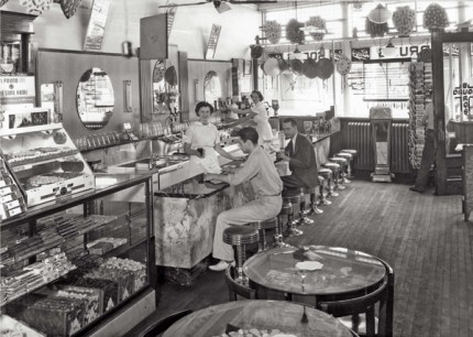 The interior of the Burg Pharmacy showing artifacts displayed on the walls. Image courtesy of the Chelsea District Library Local History Collection.