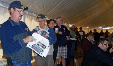 Photo by Lisa Carolin. A large crowd assembled to bid on the contents of The Wolverine on Saturday.