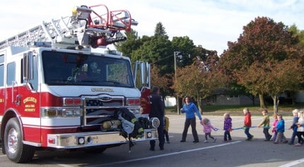 Photo by Lisa Carolin. Youngsters have a chance to climb into a fire truck. 