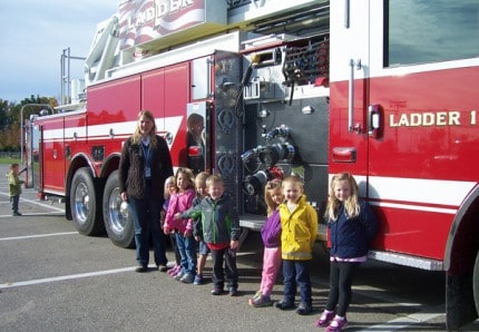 Photo by Lisa Carolin. Children have a chance to hang out on the fire truck. 