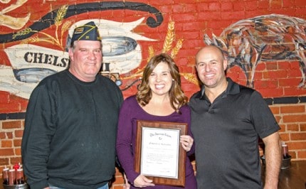 Commander Howard Flintoff presents the plaque to Phil and Jenn Tolliver.