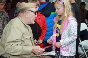 School children from South Meadows Elementary School sang "She's a Grand Old Flag" and handed veterans cards.