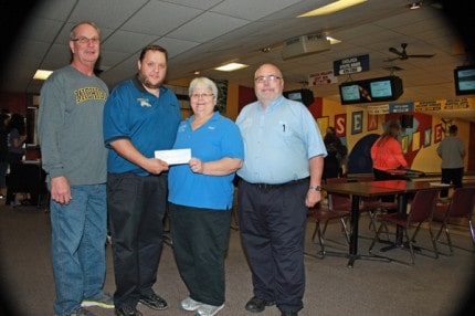 Girls bowling coach Tom Debacker on left, Head Coach Eddy Greenleaf, Joni Benson and Rick Benson, who donated $1,600 to the team Monday afternoon at Chelsea Lanes. 