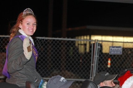 Amy Gilbert, the 2014 Chelsea Community Fair queen, waves to the crowd during the Hometown Holiday Light Parade. 