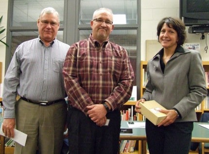 Photo by Crystal Hayduk. Board President Steve Olsen (left) thanked retiring board members for their service. Jon Bentley served a total of 11 ½ years over two terms, and Sally DeVol (right) served for eight years. “They’ve been invaluable members to this board of education,” Olsen said. “We’ve had some hot issues to deal with and some of this has not been easy. The great thing is that the board has listened to each other and respected each other’s opinions.” 