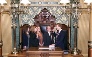 Courtesy photo. State Rep. Adam F. Zemke (D-Ann Arbor) takes the ceremonial oath of office from Michigan Supreme Court Justice Bridget Mary McCormack on Jan. 14. Left to right: Girlfriend Kelly Tebay, mother Lori Zemke and father Fred Zemke.