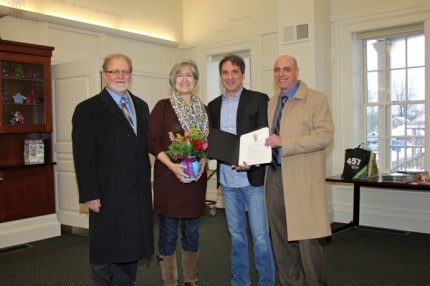 Chelsea Area Chamber of Commerce Executive Director Bob Pierce (on left) and Chamber Chamber Board  President Bruce Szcodronski (on right) honor Linda Ballard and Bill Harmer of the  Chelsea District Library with the 2014 Large Business Leadership Award. 