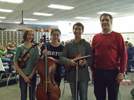 Photo by Crystal Hayduk. Katie Rae Hayduk (violin), Sophia Sjogren (cello), and Jacob Smedshammer (viola) with middle school orchestra teacher Nathan Peters.