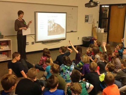 Courtesy photo. Janet Olge-Mater talks to second- graders about Chelsea history.