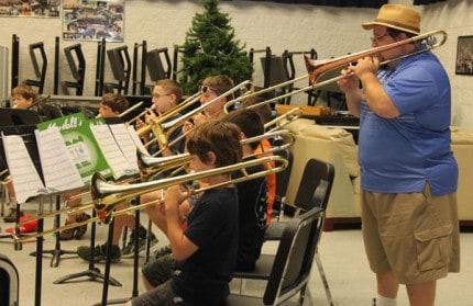 Co-director of the first Middle School Band Camp Gary Klink plays behind some of the campers Wednesday morning.