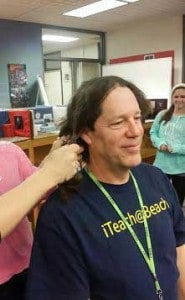 Students cut Scott Riedel's hair.