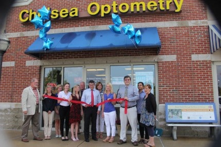 Chelsea Chamber of Commerce members flank Chelsea Optometry staff during a ribbon cutting and open house Wednesday afternoon.