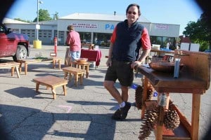 Mathew Millar of Renovatio Woodworks at the Saturday Farmers Market with some of the furniture he's produced.