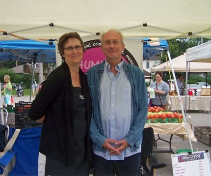 Linda Conrad and Conrad in front of the Mama Mo booth at the Saturday Farmers Market.