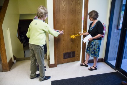 Photo by Burrill Strong. Ann Feeney and Nancy Paul cut the ribbon to the new shower facilities. 