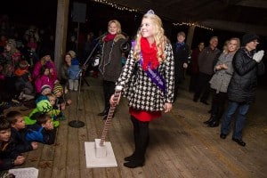 Photo by Burrill Strong. The 2015 Chelsea Community Fair Queen Alyssa Trinkle lights the Christmas tree in Pierce Park. 
