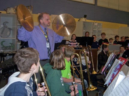 Beach Middle School Principal Nick Angel learning to play the cymbals. 