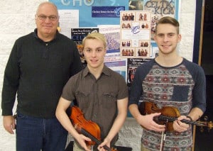 Photo by Crystal Hayduk. CHS orchestra: (Left to right) Chelsea High School Orchestra Director, Jed Fritzemeier, with Lee Argir and Aidan Carry.