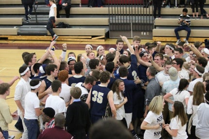 Photo by Mike Mitchell. Chelsea celebrates its victory over Dexter in boys basketball. 