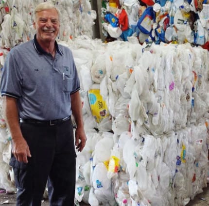 Phil Bolyard with bails of recycled material at the Western Washtenaw Recycling Authority. 