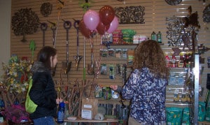 Photo by Lisa Carolin. Jennifer Fairfield (on right) assists a customer inside the Garden Mill. 