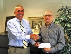 File photo. Former Superintendent of Schools Dave Killips receives a donation from Mike Jackson of Vogel's and Foster's following another successful Chelsea Gold fundraising event. 