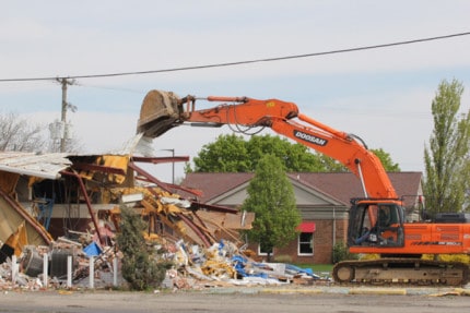 The demolition of the old Chevy dealership on M-52 began Monday.