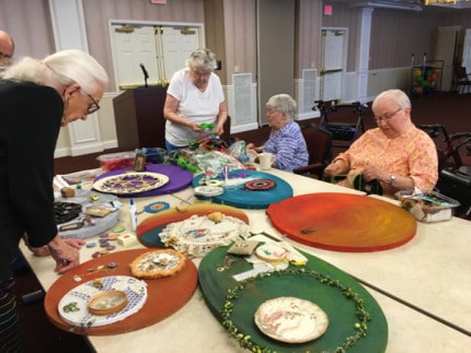 Courtesy photo. Residents of Silver Maples work with Ann Arbor Fiberarts Guild members to create a community art project called Circles of Life.