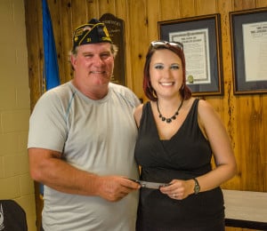 Courtesy photo by Chuck Reed. Post Commander Howard Flintoft accepts a check from Lanae Mac