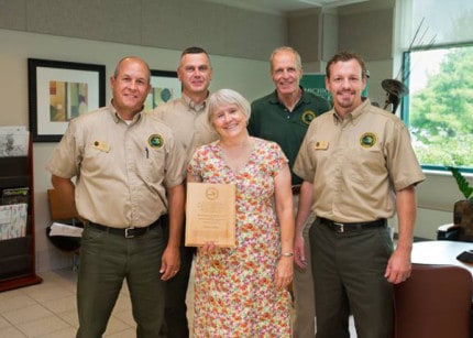 Courtesy photo. From the left are Chuck Dennison, Pinckney Recreation Area; Gary Jones, Waterloo Recreation Area; Susan Lackey, recently retired executive director of the Legacy Land Conservancy; Ron Olson, DNR Parks and Recreation Division chief; and Jim O'Brien, Hayes State Park.
