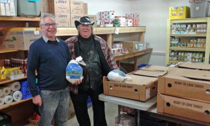 Courtesy photo from Keith Bloomensaat. The Chelsea Lions Club donated 30 12-pound turkeys to Faith in Action for Thanksgiving. In photo is Phil Radant of the Chelsea Lions Club and Doug Smith from Faith in Action.  